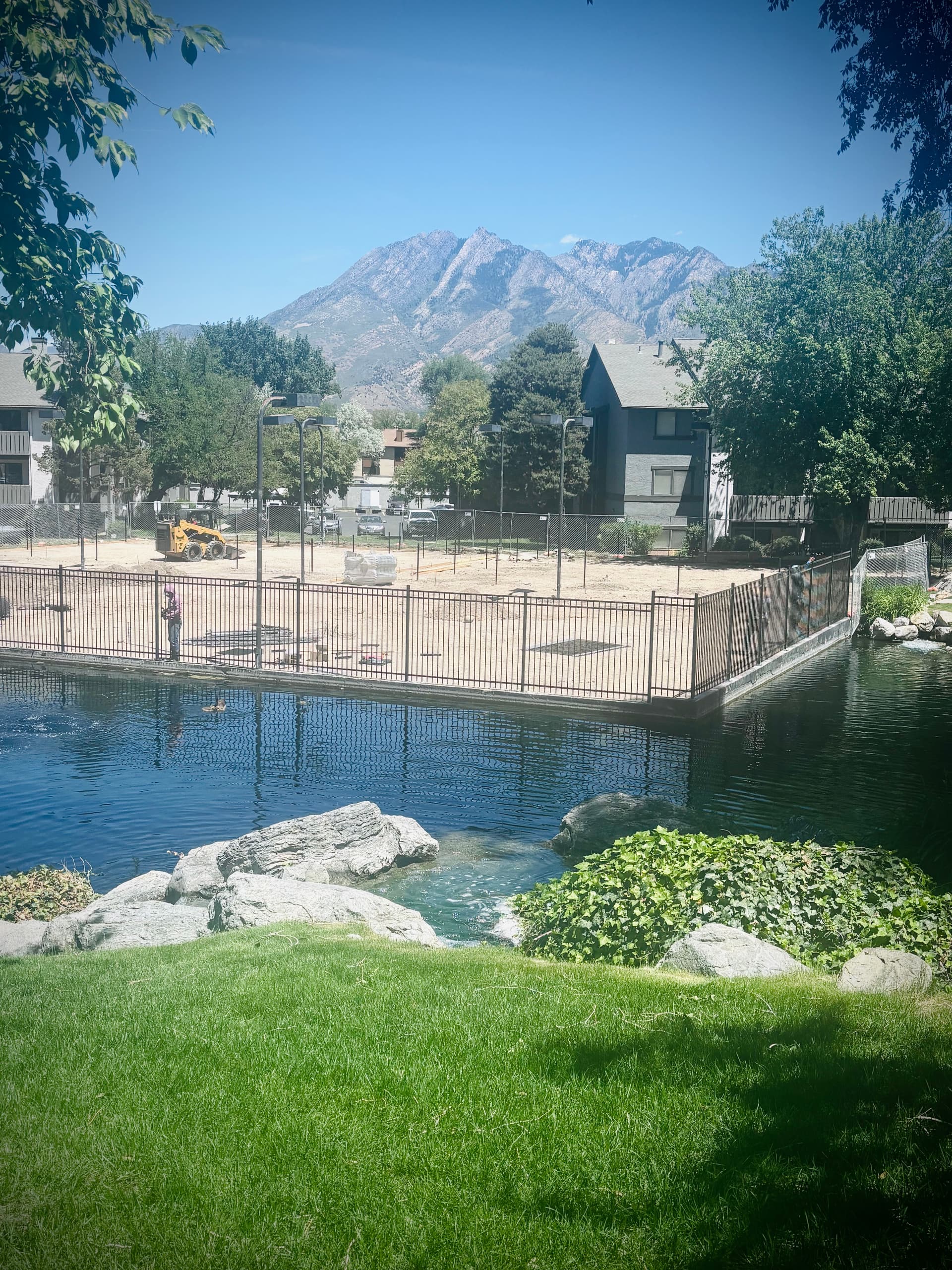 Iron Rod Fence Installation Around a Court and Pond Area image