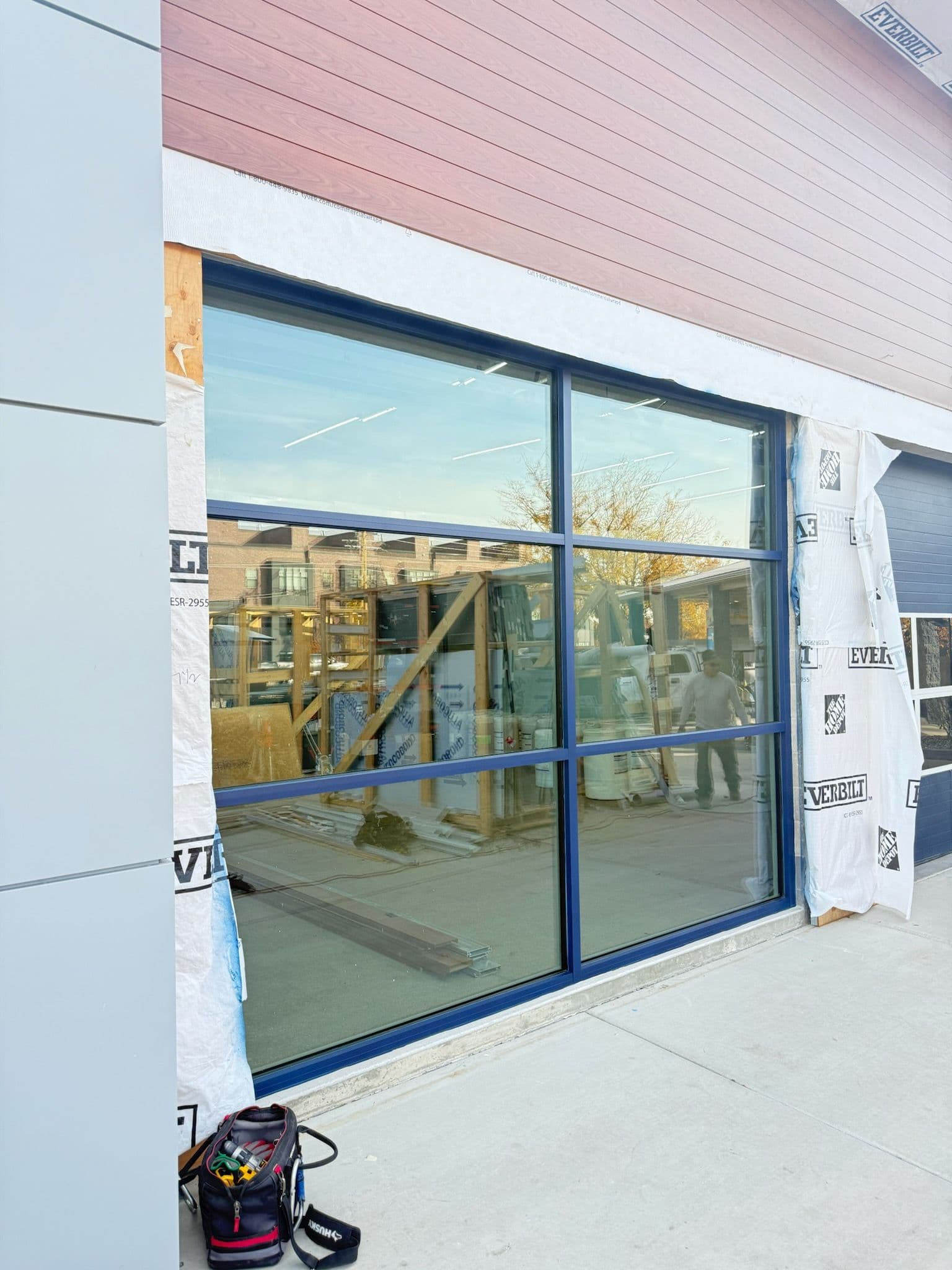 New Glass Window Installation with Custom Blue Frame Complete image