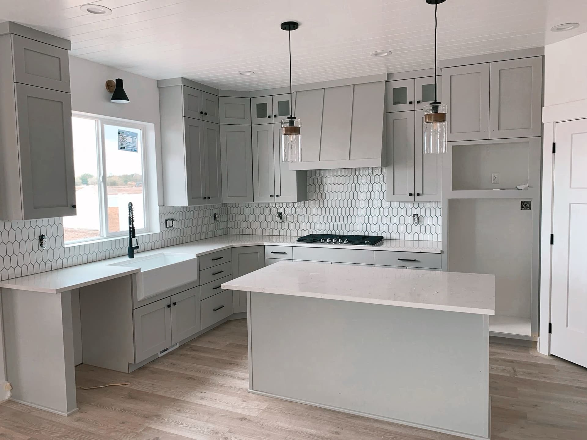 Kitchen Remodel Featuring Gray Cabinetry and Stylish Lighting image
